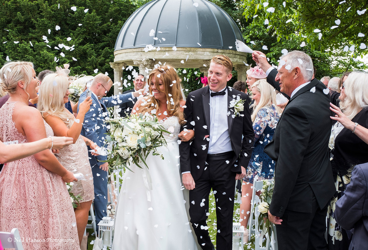 Confetti being thrown after a wedding ceremony at Ardington House
