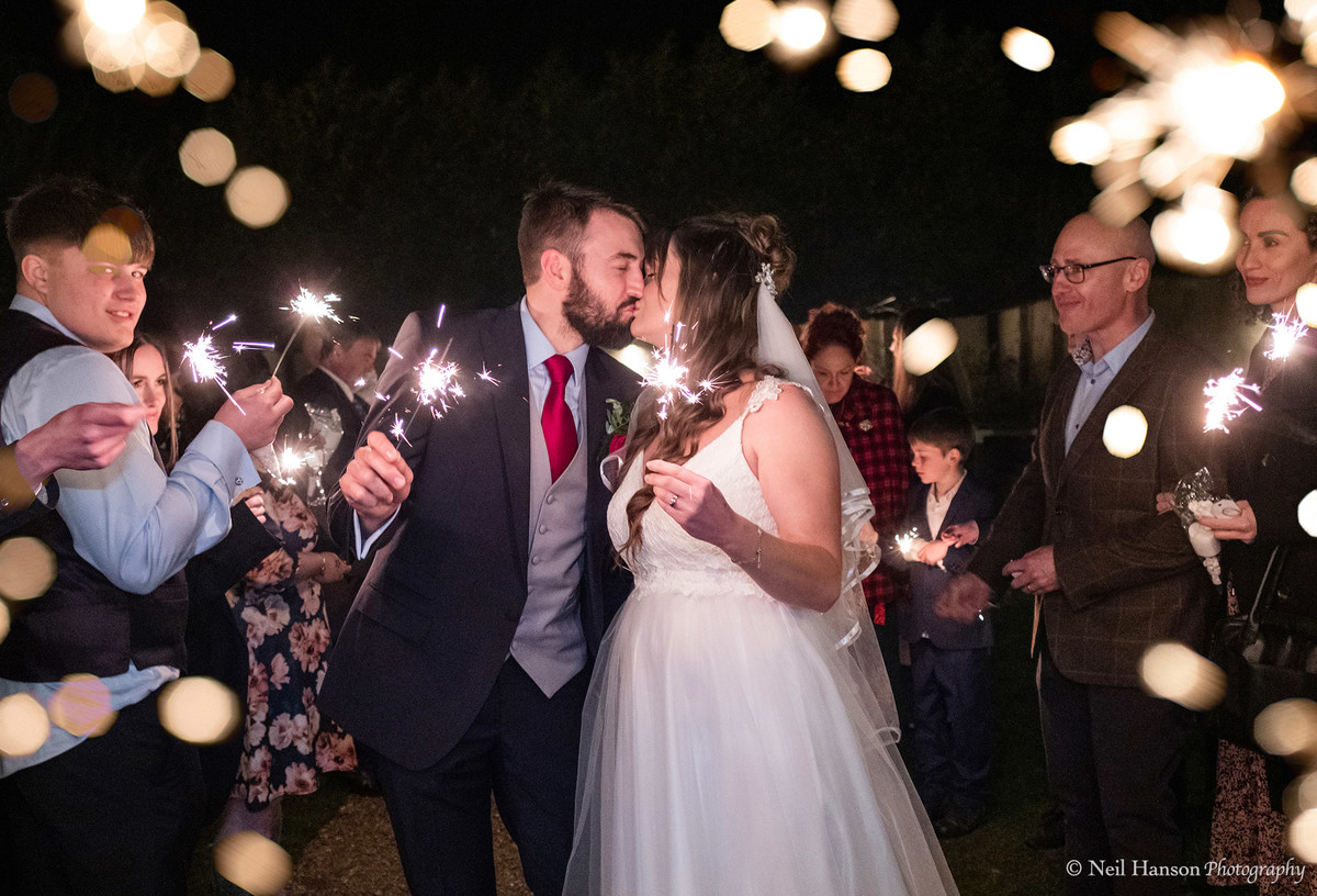 Bride and Groom with Spaklers at their Oxleaze Barn Wedding