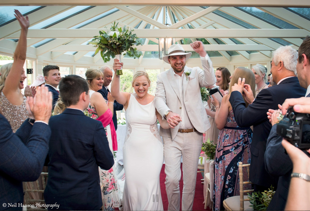 Bride and Groom walking back down the aisle after their wedding ceremony at The Bay Tree Hotel