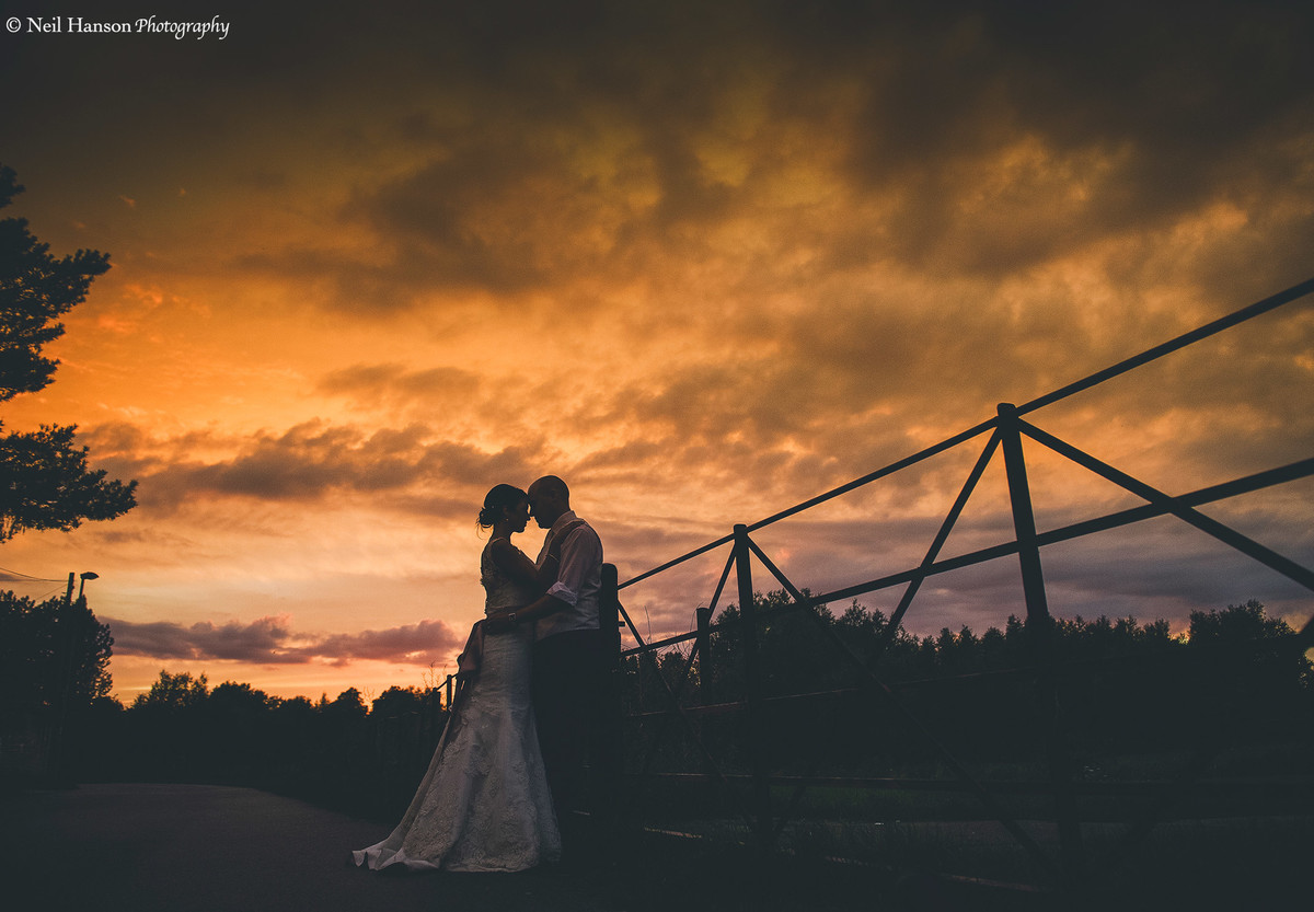 Bride and Groom enjoying a sunset on their wedding day at Cogges Manor Farm in Witney